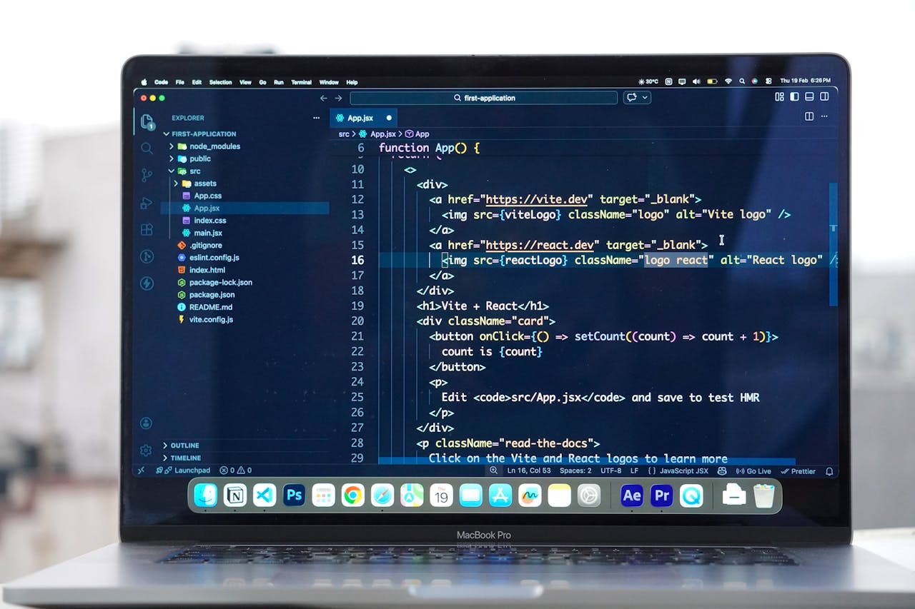 Laptop with code editor open on a rooftop, showcasing remote web development and modern work flexibility.
